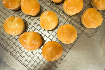 Top view of homemade bun on stainless grates. Fresh bun on stainless grates.