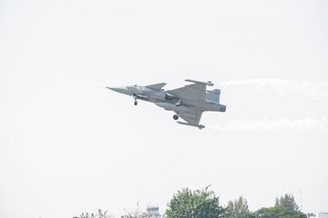 Combat aircraft practicing through the white background
