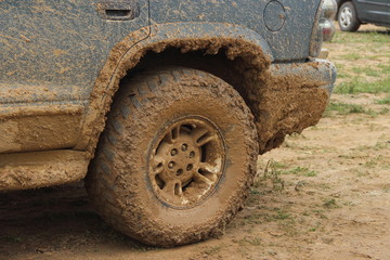 Fototapeta na wymiar Dirty rear wheel 4x4 truck close up