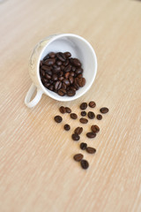 Coffee cup and coffee beans on wooden background