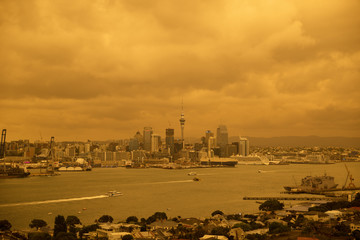 The sky over Auckland, New Zealand turns yellow and orange from smoke blown across the Tasman Sea...