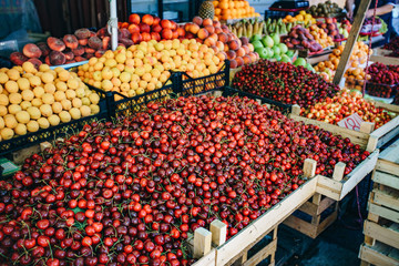 Fresh fruit in the market. Apricots, peaches, cherries, apples