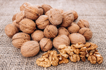 Mature walnuts on woven fabric. Nuts on linen fabric