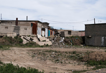 Fototapeta na wymiar Abstract architectural background. Garages. Garage cooperative. Kazakhstan, Ust-kamenogorsk, may 2019. Unfinished buildings