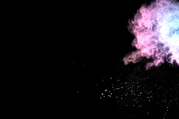 Colorful powder explosion on black background. 