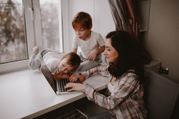 mother with children with laptop online shopping