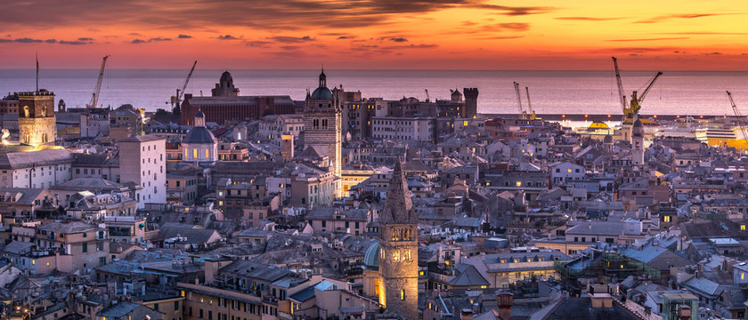 Genoa, Genova, Italy: Amazing sunset panoramic aerial view of Genoa old town historic centre (San Lorenzo Cathedral, duomo, Palazzo Ducale, Torre Grimaldina), sea and port at dusk, by night. Panorama © Luca