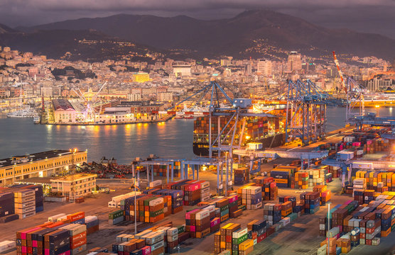 Genova, Genoa, Italy: Aerial view of shipping and container terminal, stacked containers and loading dock side cranes in the port of Genoa, Magazzini del cotone and Porto Antico, sea