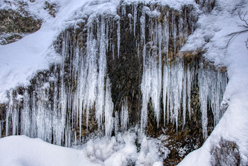 Fototapeta na wymiar Large stalactites with ice in the mountains on a rock , slovakia mala fatraLarge stalactites with ice in the mountains on a rock , slovakia mala fatra