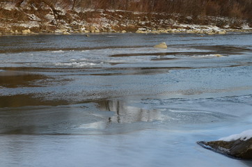 winter landscape in the forest with snow and blue sky and river