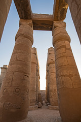 Ancient egyptian hieroglyphic carvings on columns in temple