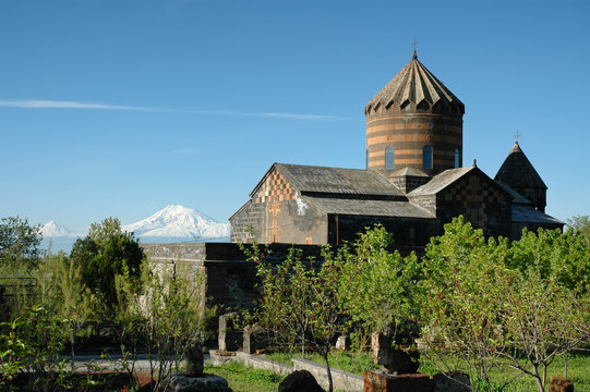 Mughni Monastery (17h century) and Ararat Mountain on the background. Mughni village, Aragatsotn Region, Armenia.