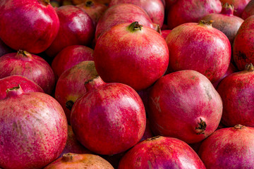 Fototapeta na wymiar Group of pomegranates. Pomegranate closeup, background pomegranate