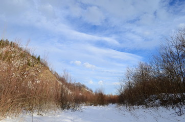 Naklejka na ściany i meble winter landscape in the forest with snow and blue sky and river