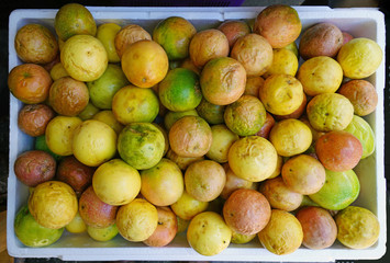 Crate of colorful ripe passion fruits at a food market