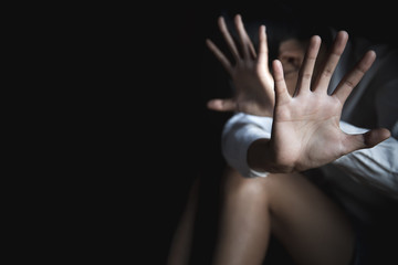 Scared young woman sitting in the corner of her bedroom, despair rape victim waiting for help,The...