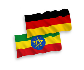 National vector fabric wave flags of Germany and Ethiopia isolated on white background. 1 to 2 proportion.