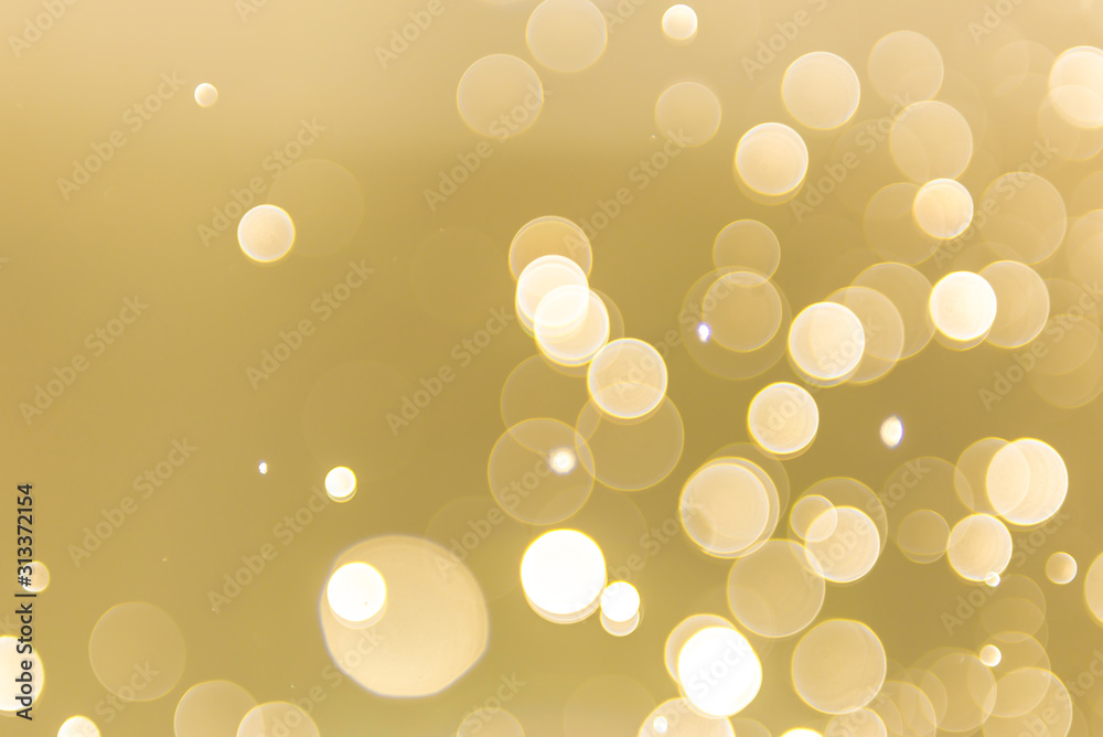 Wall mural abstract gold background with soft blur bokeh light effect, background bokeh