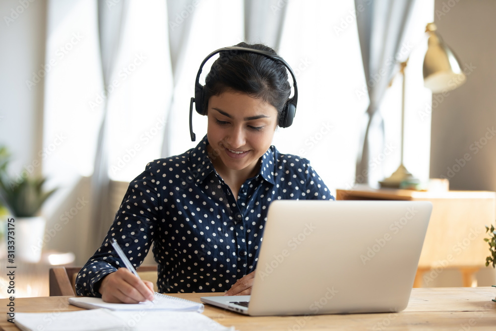 Canvas Prints indian girl student wear headset study online teacher write notes