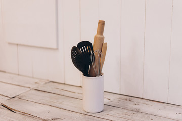 kitchen utensils on white wooden background