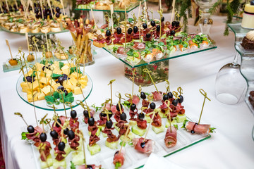 Catering. Off-site food. Buffet table with various canapes, sandwiches, hamburgers and snacks.