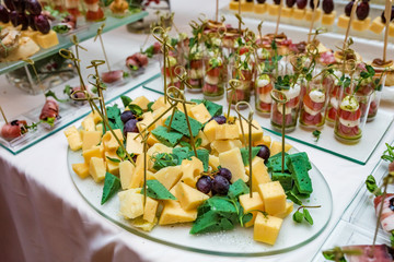 Catering. Off-site food. Buffet table with various canapes, sandwiches, hamburgers and snacks.
