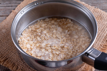 Oatmeal porridge in a saucepan