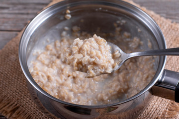 Oatmeal porridge in a saucepan