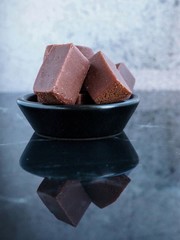 Chocolate fudge on reflective surface