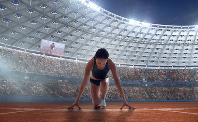 Athlete woman on the starting blocks on sport championship.