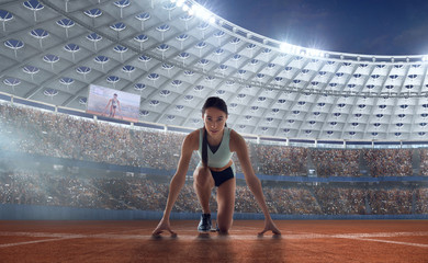 Athlete woman on the starting blocks on sport championship.