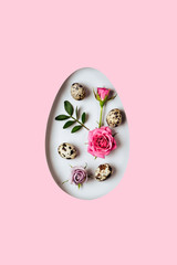 Minimal Happy easter concept. Egg shaped hole. Composition with flowers and quail eggs