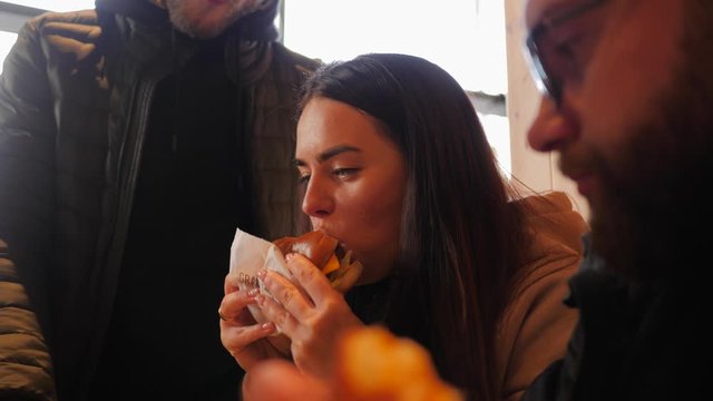 Hang out guys friends eat in fast food restaurant hamburgers french fries potatoes and chicken nuggets drinking alcohol beer