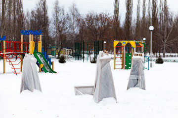 trees in a park covered with special cloth sheets to protect them from frost