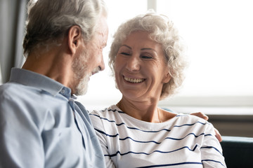 Fototapeta na wymiar Elderly cheerful grandmother laughing having pleasant conversation with grandfather