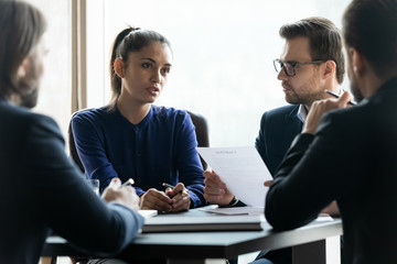 Businesspeople brainstorm discussing cooperation at office briefing