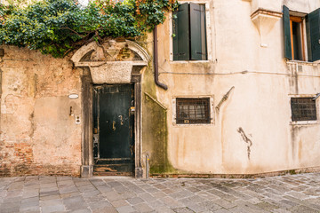 Fototapeta na wymiar Vintage european style building facade with door and windows in Venice, Italy.