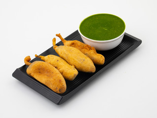 Indian Street Fried Food Spicy Chilli Pakora Served With Sauce & Chutney Also Know as Mirchi Bajji, Mirchi Vada, Mirchi Bada, Chili Cutlet or Chili Bajji It's a Popular Tea Time Snacks From India