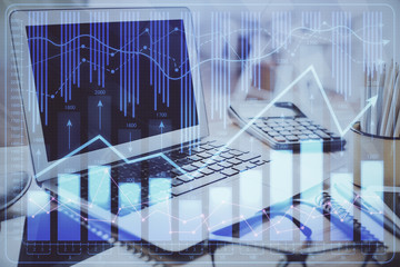 Financial graph colorful drawing and table with computer on background. Double exposure. Concept of international markets.