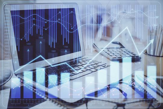 Financial graph colorful drawing and table with computer on background. Double exposure. Concept of international markets.