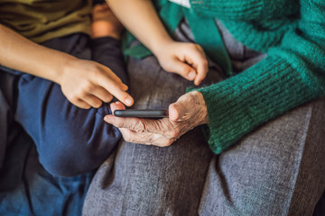 Grandmother and grandson are looking at a smartphone