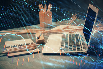 Double exposure of chart and financial info and work space with computer background. Concept of...