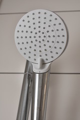 Shower Head. A shower from which water pours.