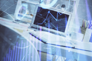 Stock market graph and table with computer background. Double exposure. Concept of financial analysis.