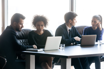 Multiracial businesspeople work together collaborating at meeting