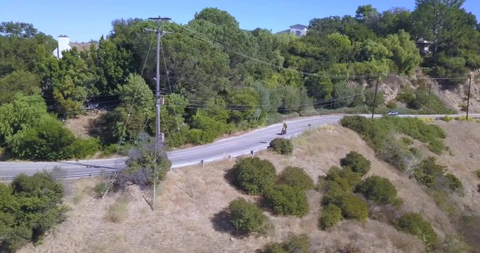 4k drone aerial footage motorcycle rider through hollywood hills mulholland drive los angeles california