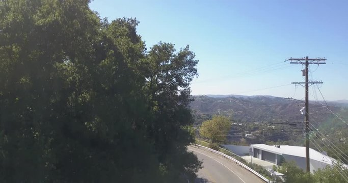 4k drone aerial footage motorcycle rider through hollywood hills mulholland drive los angeles california