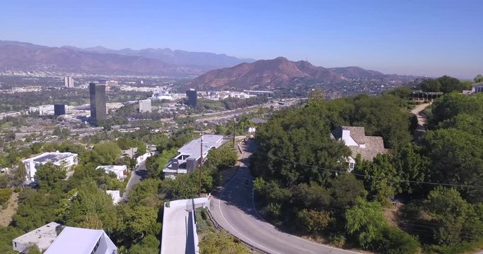 4k drone aerial footage motorcycle rider through hollywood hills mulholland drive los angeles california