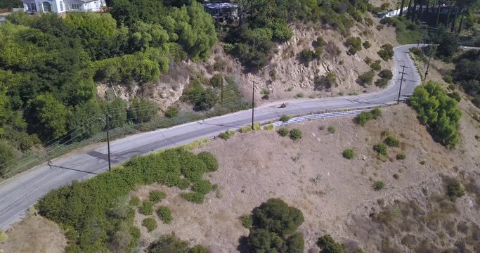 4k drone aerial footage motorcycle rider through hollywood hills mulholland drive los angeles california