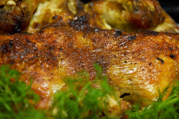 A piece of delicious fried chicken with a golden crust looks very appetizing on a tray. Close-up...